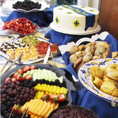 Table display with custom cake, scones, fresh fruits and hors devours